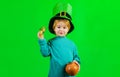 Cute child with pot of gold. Patricks day celebrations. Little boy in Leprechaun hat. Coins. Money. Royalty Free Stock Photo