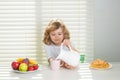 Cute child pouring whole cows milk. Healthy nutrition for children. Cute boy enjoy eating for morning breakfast with Royalty Free Stock Photo