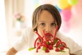 Cute child, preschool boy, celebrating birthday at home with homemade cake with raspberries, mint and candies