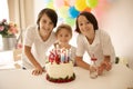 Cute child, preschool boy, celebrating birthday at home with homemade cake with raspberries, mint and candies