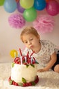 Cute child, preschool boy, celebrating birthday at home with homemade cake with raspberries, mint and candies