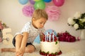 Cute child, preschool boy, celebrating birthday at home with homemade cake with raspberries, mint and candies