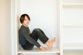 Cute child, sit in a white box in open wardrope Royalty Free Stock Photo