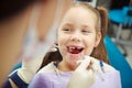 Cute child sits at dentist chair with smile Royalty Free Stock Photo