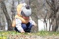 Cute child sitting in the park with flower