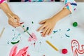 Cute child sitting at the table and drawing red heart on white paper Royalty Free Stock Photo