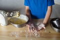 A cute child smeared his hands in flour.