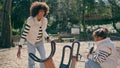 Cute child spinning carousel in playground with mother. Active happy childhood.