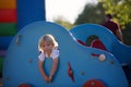 Cute child, toddler boy, playing on the playgroung on cute car