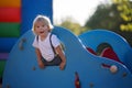 Cute child, toddler boy, playing on the playgroung on cute car