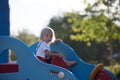 Cute child, toddler boy, playing on the playgroung on cute car