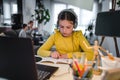 Cute child with headphones using laptop computer for online learning. Home school. Girl doing homework at home Royalty Free Stock Photo