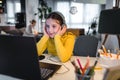 Cute child with headphones using laptop computer for online learning. Home school. Girl doing homework at home Royalty Free Stock Photo