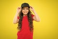 Cute child wear cap or snapback hat. Little girl wearing baseball cap. Summer sun protection cap. Girl long curly hair