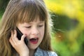 Cute child young girl talking on cellphone outdoors. Children and modern technology, communication concept Royalty Free Stock Photo