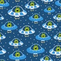 Cute childish alien spaceships dotted seamless pattern on dark background, ideal for bedding design