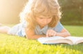 Cute childr boy with books outdoors. Summer camp. Kids learning and education concept. Royalty Free Stock Photo