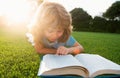 Cute childr boy with books outdoors. Summer camp. Kids learning and education concept. Royalty Free Stock Photo