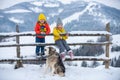 Cute children boy and girl playing on a winter walk in nature. Portrait of happy little kids wearing winter clothes Royalty Free Stock Photo