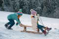 Cute children boy and girl playing on a winter walk in nature. Winter knitted kids clothes. Cold weather. Happy little