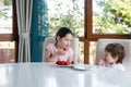 Cute children eating fresh ripe strawberries at home Royalty Free Stock Photo