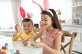 Cute children with bunny ears headbands painting Easter eggs Royalty Free Stock Photo