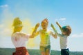 Cute children celebrate Indian holi festival with color.