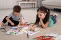 Cute children coloring drawings on floor