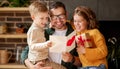 Cute children congratulating happy daddy with Fathers day and giving him handmade greeting postcard Royalty Free Stock Photo