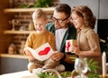 Cute children congratulating happy daddy with Fathers day and giving him handmade greeting postcard Royalty Free Stock Photo