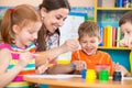 Cute children drawing with teacher at preschool class