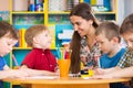 Cute children drawing with teacher at preschool class Royalty Free Stock Photo