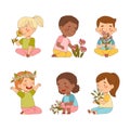 Cute children with flowers set. Happy kids sitting and smelling wildflowers cartoon vector illustration Royalty Free Stock Photo