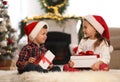 Cute children holding gift boxes in room decorated for Christmas Royalty Free Stock Photo