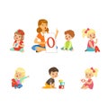 Cute Children Learning Alphabet and Playing in Nursery School with Teacher Sitting on the Floor with Card and Cube