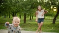 Cute children making rhythmical movements outdoors. Brother and sister dancing