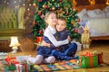 Cute children play lying on the floor in a festively decorated room