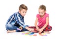 Cute children playing with large colorful alphabet letters on white background. Kids speech therapy concept. Dyslexia.