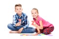 Cute children playing with large colorful alphabet letters on white background. Kids speech therapy concept.