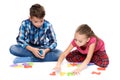 Cute children playing with large colorful alphabet letters on white background. Kids speech therapy concept.