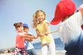 Cute children pulling rope during tug of war game on beach. Summer camp Royalty Free Stock Photo