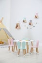 Cute children`s room interior with teepee tent and table