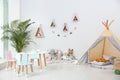 Cute children`s room interior with teepee tent and little table