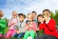 Cute children sit in the meadow with magnifiers Royalty Free Stock Photo