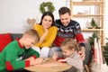 Cute children with their parents making beautiful Christmas greeting cards at home Royalty Free Stock Photo