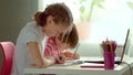Cute children use laptop for education, online study, home studying. Boy and Girl have homework at distance learning