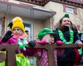 Cute children watching the St. Patrick parade from a float in downtown Quebec City