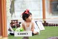 Cute Chinese baby girl play flowers in a garden Royalty Free Stock Photo