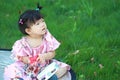 Cute Chinese baby girl play glasses on the lawn Royalty Free Stock Photo