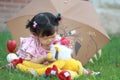 Cute Chinese baby girl play plush toy on the lawn Royalty Free Stock Photo